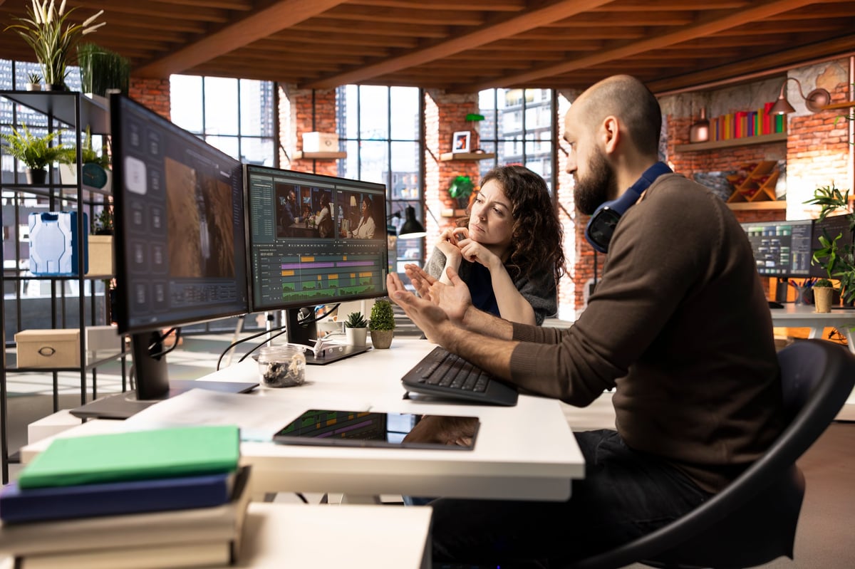 Editorial team collaborating on a media montage project with post-production color grading software