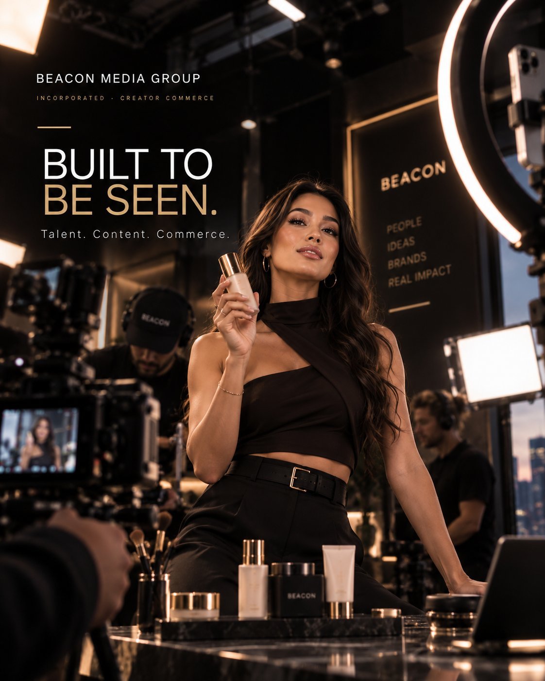 Woman in black outfit holding cosmetic product at vanity with neon lights and text reading Built To Be Seen for Beacon Media Group